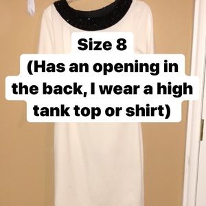 White dress with a Gem neck line.